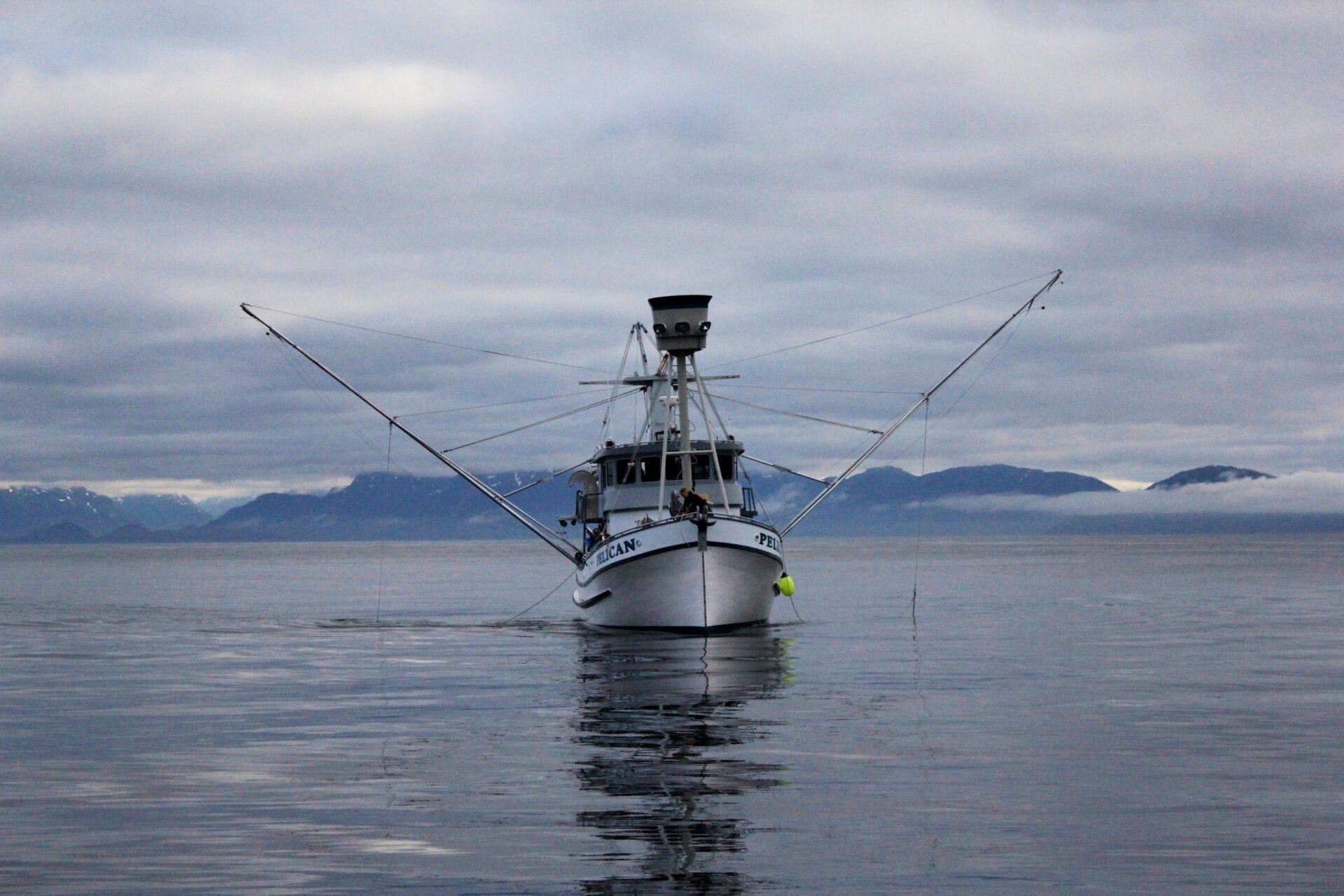 A boat is in the water with two fishing rods.